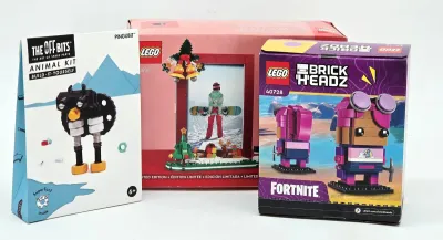 Three boxed building toy kits, including a Lego BrickHeadz Fortnite set, a Lego limited edition picture frame set, and a The Off Bits...