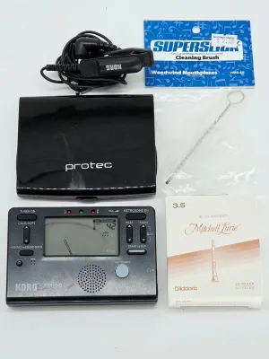Korg TM-60 tuner and metronome combo with a clip-on microphone, a Protec accessory case, a Superslick woodwind mouthpiece cleaning brush,...