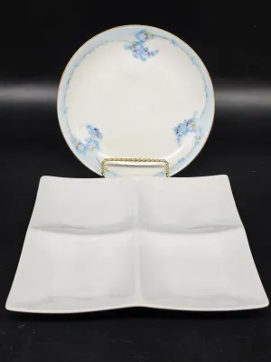 Vintage porcelain serving dishes, including a round plate with delicate blue floral details and a gold rim, paired with a modern white...