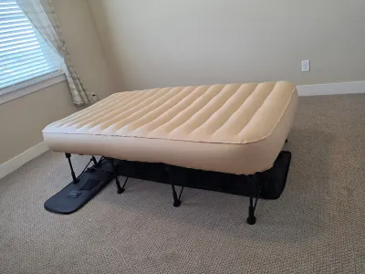 EZ Bed inflatable air mattress with self-deploying folding frame and integrated storage case.