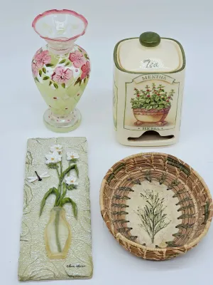 Assorted decorative items including a hand-painted floral glass vase, a ceramic Mentha Herba tea canister, a 3D floral wall plaque, and a...