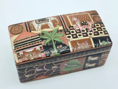 Vintage hand-painted ceramic trinket box featuring Indian-style illustrations of an elephant, horse, palm tree, and other traditional...