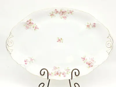 Antique Haviland Limoges porcelain oval platter featuring delicate pink rose swags, a scalloped rim, and gold-accented handles.