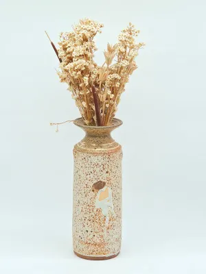 Studio art pottery vase featuring a speckled beige glaze with a white and brown abstract drip design, holding a bouquet of dried flowers.