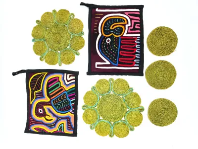 Collection of vintage table linens, including two colorful mola-style embroidered pot holders featuring bird motifs and a set of woven...