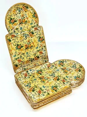 Vintage Florentine papier-mâché tray set, featuring a vibrant yellow floral and bird pattern with gilded edges, showing some wear...
