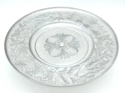 Vintage mid-century hammered aluminum serving platter featuring an embossed floral and leaf design with a beaded rim.