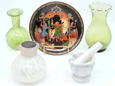 Assorted decorative items including a Russian lacquer-style collector plate, two green glass vases, a white art glass decanter, and a...