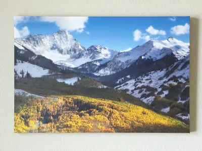 Large canvas print depicting a scenic mountain landscape with snow-capped peaks and vibrant autumn foliage in the foreground.