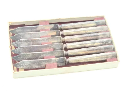 Set of six vintage 1835 R. Wallace silver-plated steak knives with octagonal handles, showing some tarnish, presented in their original...