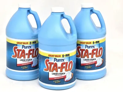 Three 64-ounce jugs of Purex Sta-Flo concentrated liquid starch, suitable for laundry or craft projects.