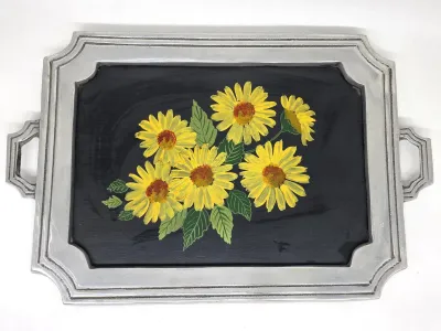 Vintage cast metal serving tray with integrated handles, featuring a hand-painted sunflower bouquet on a black background.