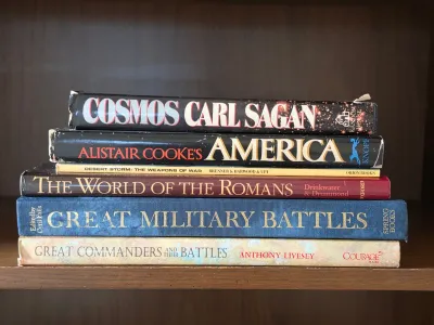 Stack of six hardcover non-fiction books on history and science, including Carl Sagan's "Cosmos" and Alistair Cooke's...