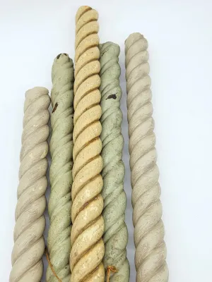 Five vintage spiral-carved wooden spindles in varying shades of beige and sage green, showing some wear and paint loss.