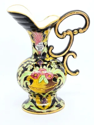 Vintage BH Renaissance hand-painted Belgian ceramic pitcher, featuring a black glaze with vibrant floral motifs and ornate gold-gilded...
