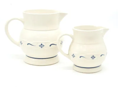 Pair of Pfaltzgraff Yorktowne pattern ceramic pitchers in graduated sizes, featuring the classic blue floral motif on a gray-white glaze.
