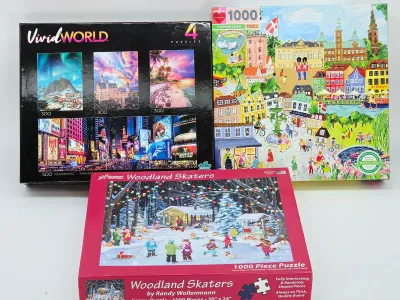 Three jigsaw puzzle boxes, including a Vivid World 4-puzzle set, an eeBoo 1000-piece Copenhagen puzzle, and a Vermont Christmas Company...