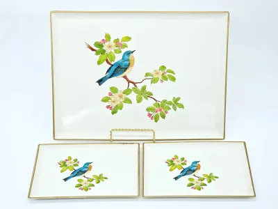 Couroc of Monterey three-piece tray set featuring a bluebird perched on a flowering branch, with gold-rimmed borders.