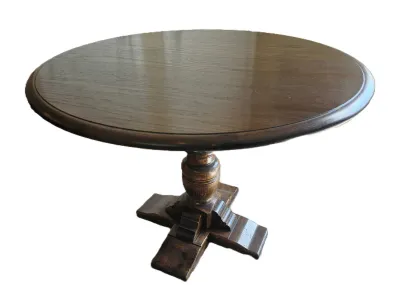 Vintage round wooden pedestal side table with a dark finish and a carved four-legged base.