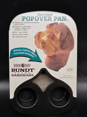 Nordic Ware Bundt brand Pro-Cast Popover Pan in its original packaging, featuring a non-stick interior and six 1-cup molds.