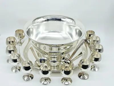 Vintage silver-plated punch bowl set, including a large pedestal bowl, matching underplate, ladle, and twelve small footed cups.