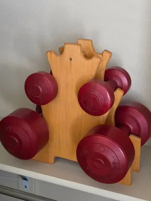 Vintage Bollinger red vinyl-coated dumbbell set with a custom wooden A-frame storage rack.