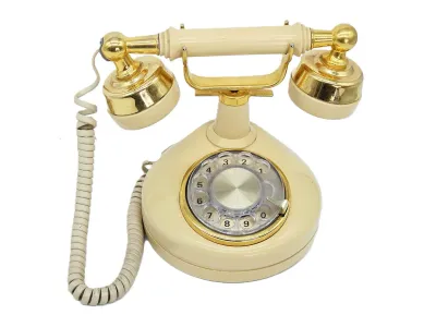 Vintage cream-colored rotary telephone with gold-tone accents and a matching handset, styled in a classic mid-century design.