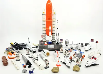 Vintage NASA space exploration toy playset featuring a space shuttle with external tank and boosters, various rockets, lunar landers,...