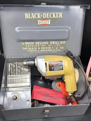 Vintage Black & Decker Utility 1/4-inch deluxe drill kit in its original gray metal carrying case, including a yellow-bodied drill,...