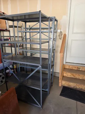 Two heavy-duty gray metal shelving units with adjustable shelves, suitable for garage or basement storage.