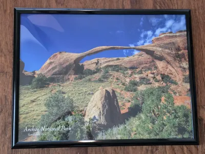 Framed poster of Landscape Arch in Arches National Park, Utah, housed in a simple black frame.