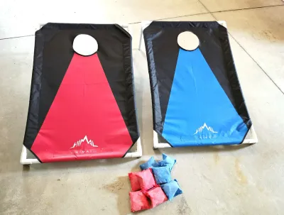 Himal collapsible cornhole game set featuring red and blue fabric targets on PVC frames, complete with matching bean bags.