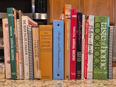 Collection of vintage and modern cookbooks, including titles from Southern Living, Amy Vanderbilt, and Taste of Home, displayed on a...