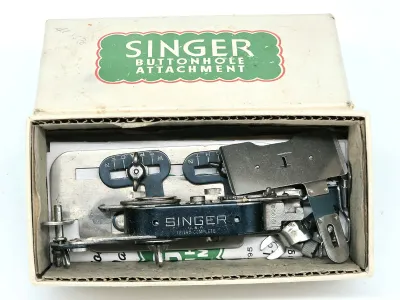 Vintage Singer buttonhole attachment set, model 121795, complete in its original cardboard box with instructions.