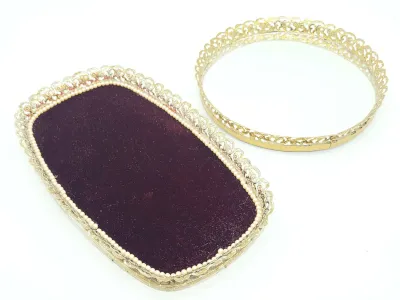 Vintage Hollywood Regency vanity trays, including a rectangular tray with purple velvet lining and faux pearl trim, and a round mirrored...