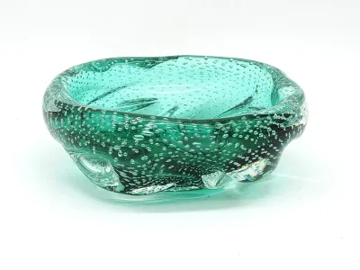 Mid-century modern Murano-style green art glass bowl featuring a bullicante controlled bubble pattern.