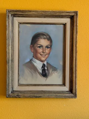 Vintage pastel portrait of a young boy, signed and dated 1966, housed in a rustic wooden frame with a linen liner.