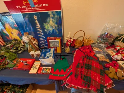 Assorted Christmas decorations, including a Holiday Living 7-foot clear rope spiral tree in its original box, a Santa figurine, an elf...
