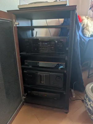 Wooden media cabinet housing a Denon AV receiver, an LG Blu-ray player, and a Sony CD changer.
