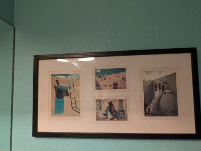 Framed Southwestern-themed multi-photo collage featuring images of adobe architecture and Native American culture, housed in a dark...
