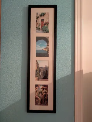 Vertical collage frame featuring four travel photographs of European landscapes and architecture, housed in a simple black frame with a...