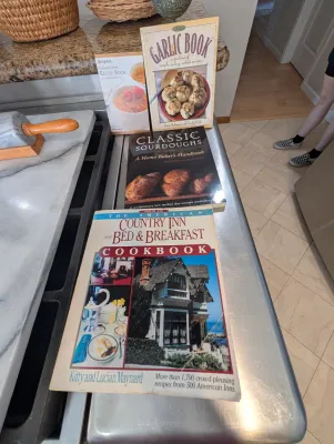 A collection of vintage cookbooks, including "The American Country Inn and Bed & Breakfast Cookbook," "Classic...