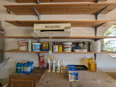 Assorted garage and household chemicals, including sealers, cleaners, and paints.