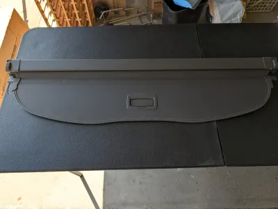 Retractable black cargo cover for an SUV or hatchback, in clean, gently used condition.
