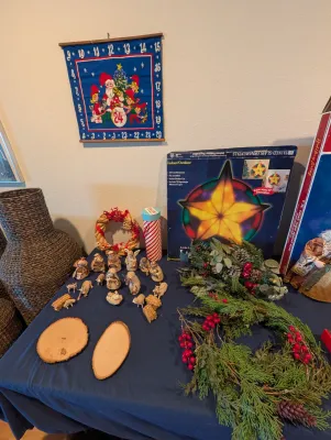 Assorted vintage Christmas decorations, including a fabric advent calendar, a miniature nativity set, a light-up star decoration in its...