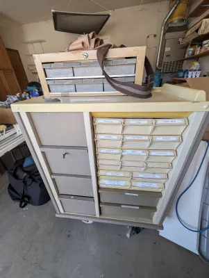Rolling medical medication cart converted into a tool chest with small tools and screws, etc.