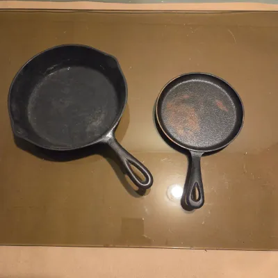 Sale Photo Thumbnail #426: Two cast iron skillets. #5 -  2 notch Lodge and a little skillet