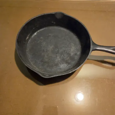 Sale Photo Thumbnail #430: Two cast iron skillets. #5 -  2 notch Lodge and a little skillet