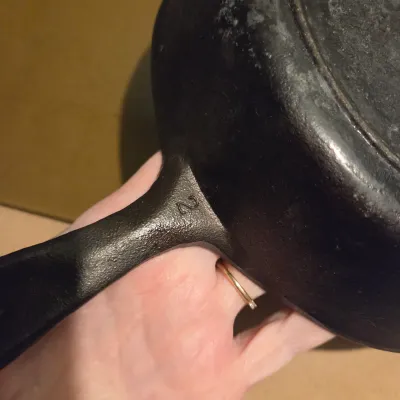 Sale Photo Thumbnail #433: Two cast iron skillets. #5 -  2 notch Lodge and a little skillet