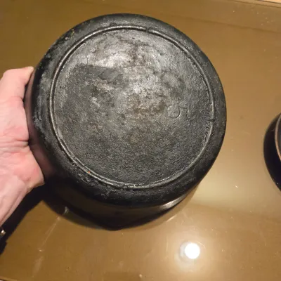 Sale Photo Thumbnail #432: Two cast iron skillets. #5 -  2 notch Lodge and a little skillet